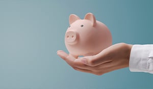 A hand extended outward holding a piggy bank