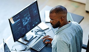 Man sitting at a computer analyzing data