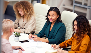 Corporate women sitting at a conference table 