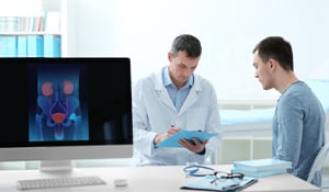 Urologist discusses medical information with a young male patient